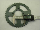 Dark green metal sprocket measured with digital caliper showing 52.17 mm on white surface
