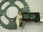 Digital caliper measuring 8.62 mm on a gray metal sprocket gear teeth