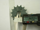 Measuring 14.32mm inner diameter of gray metal sprocket gear using digital caliper on white background