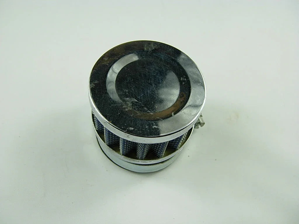 Chrome air filter with mesh screen on white background