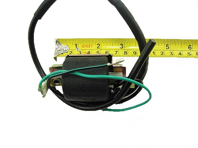 Small black ignition coil with green and black wires, placed in front of yellow measuring tape showing 6 inches