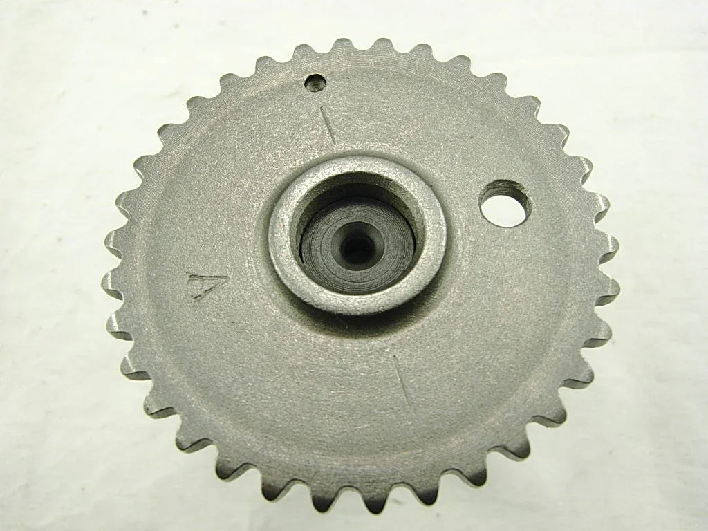 metal gear sprocket with 34 teeth and central hole on white surface