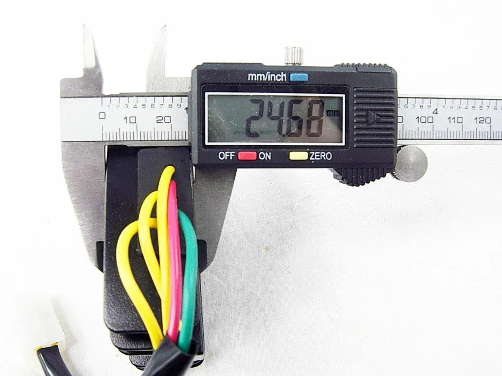 Digital caliper measuring 24.68 mm width of black electrical component with yellow, red, and green wires