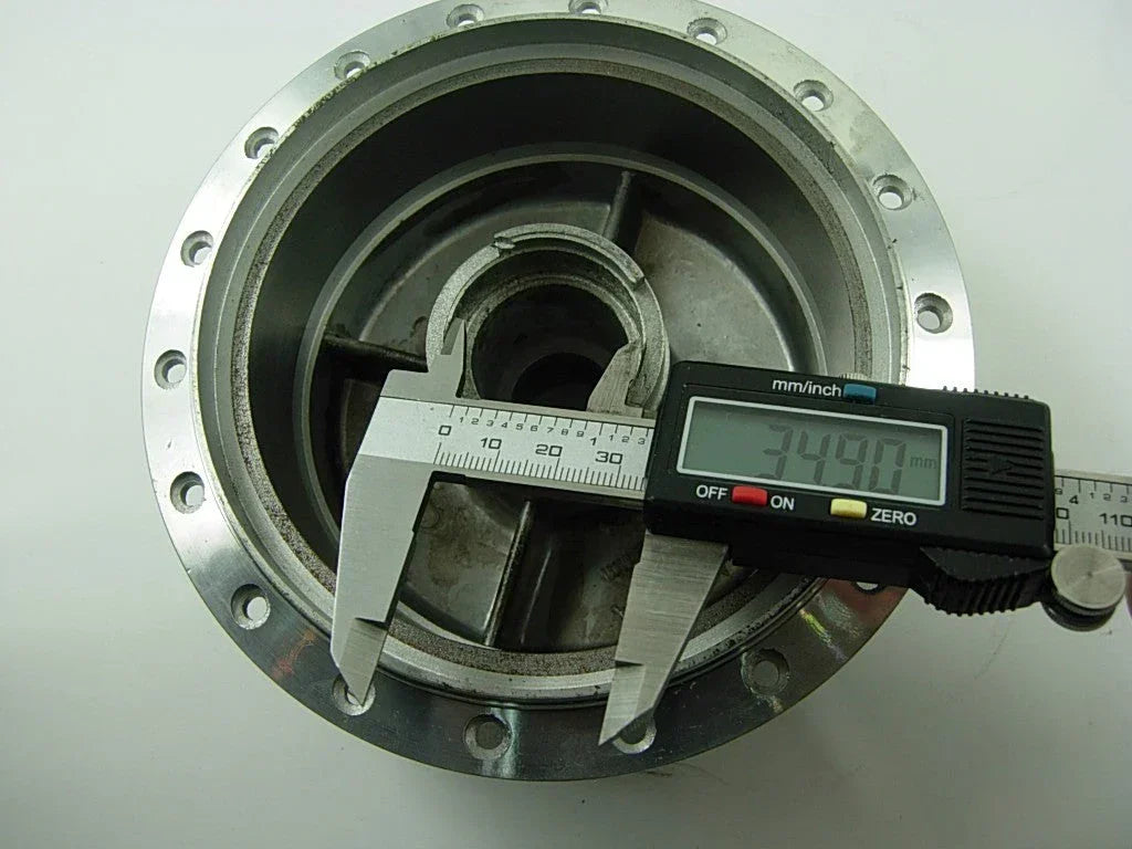 Front wheel hub for A100 engine motorcycle, metal part with mounting holes, designed to connect the wheel and axle.