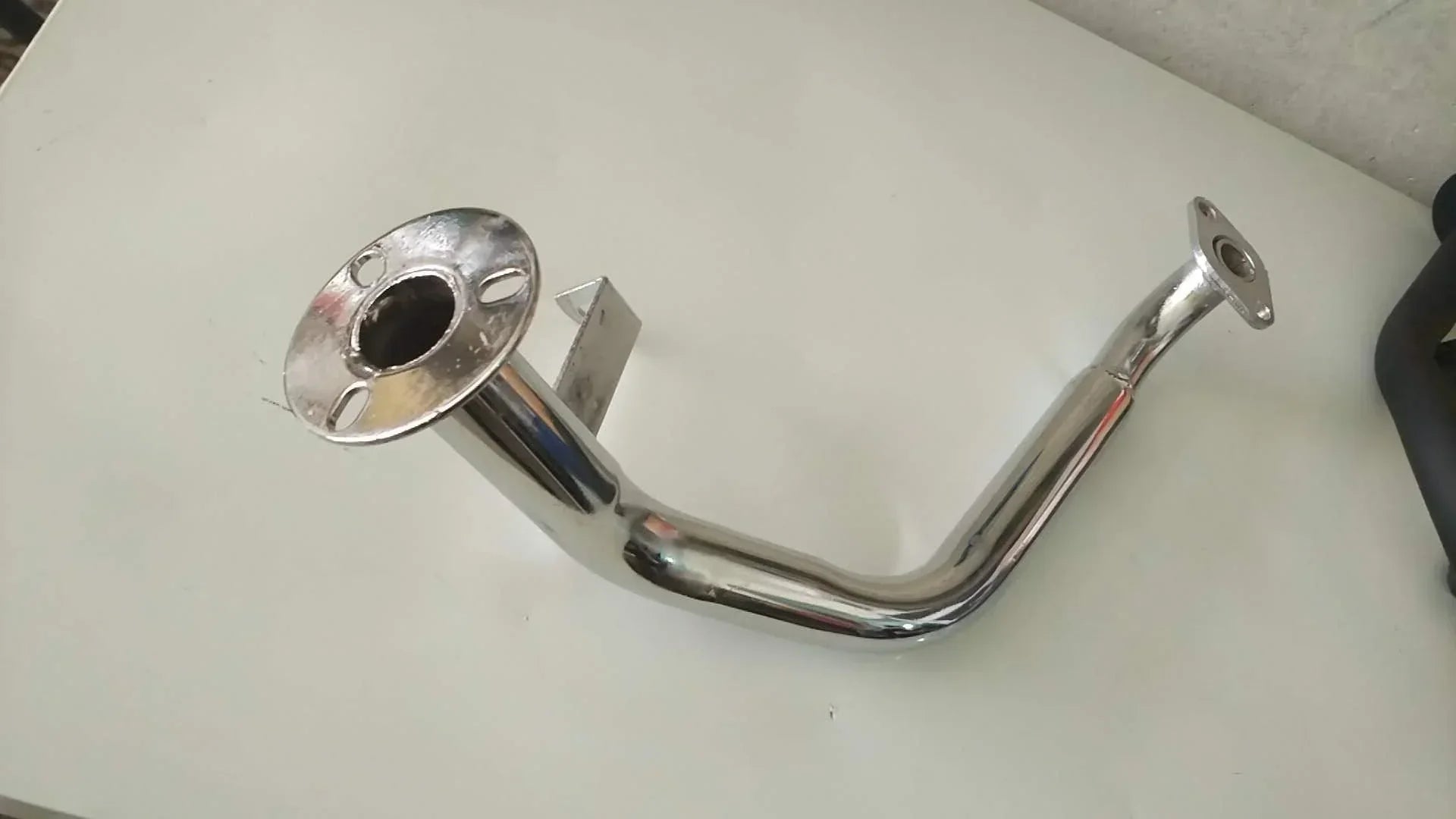 Chrome exhaust pipe for motorcycle or ATV with flanged ends and mounting bracket