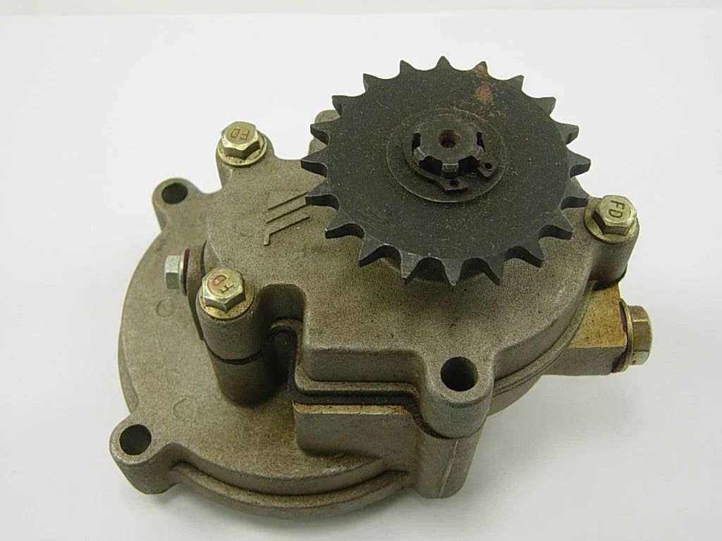 metal mechanical gear pump with black sprocket and four hex bolts on white background
