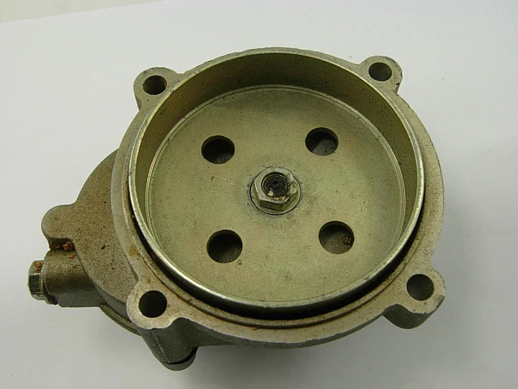 metal mechanical part with circular plate and four holes on white background