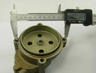 Digital caliper measuring diameter of a metal mechanical part with holes and central bolt