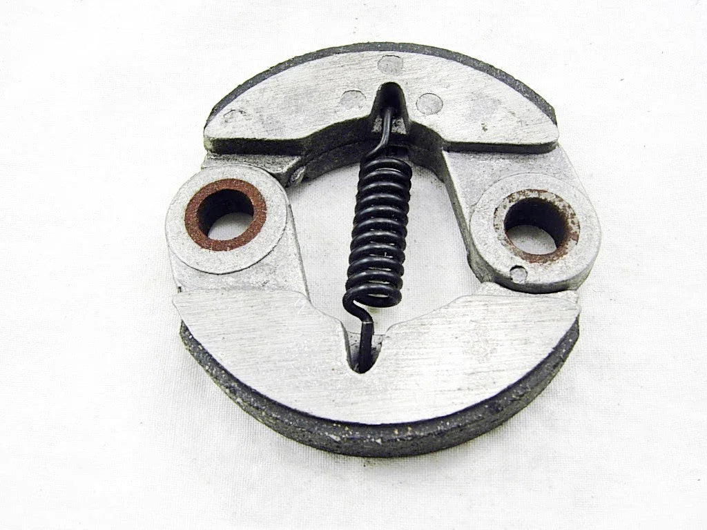 Round metal centrifugal clutch with central black spring on white background