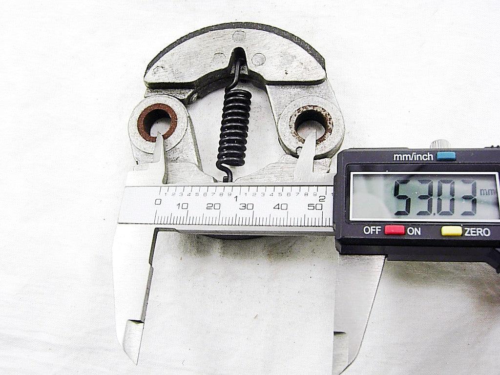 Digital caliper measuring 53.03 mm on a metal spring clutch part against white background