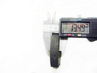 Digital caliper measuring thickness of a black rubber washer showing 13.49 mm