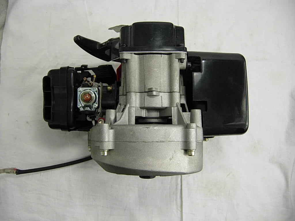 Top view of a compact black and silver gasoline engine on white background