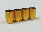 Set of four gold tire air valve stem caps with textured grip, for automotive wheels
